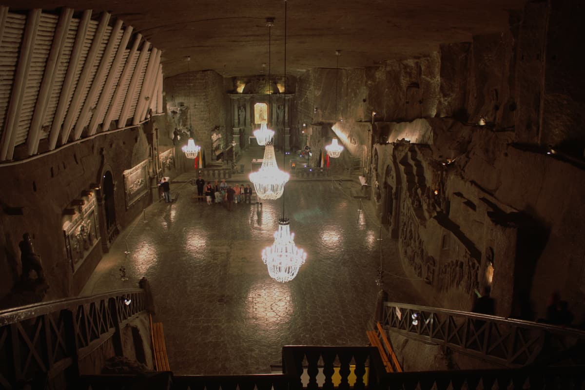 St Kinga's Chapel deep inside the Wieliczka Salt Mine near Kraków — a vast underground church carved entirely from rock salt, lit by salt-crystal chandeliers.